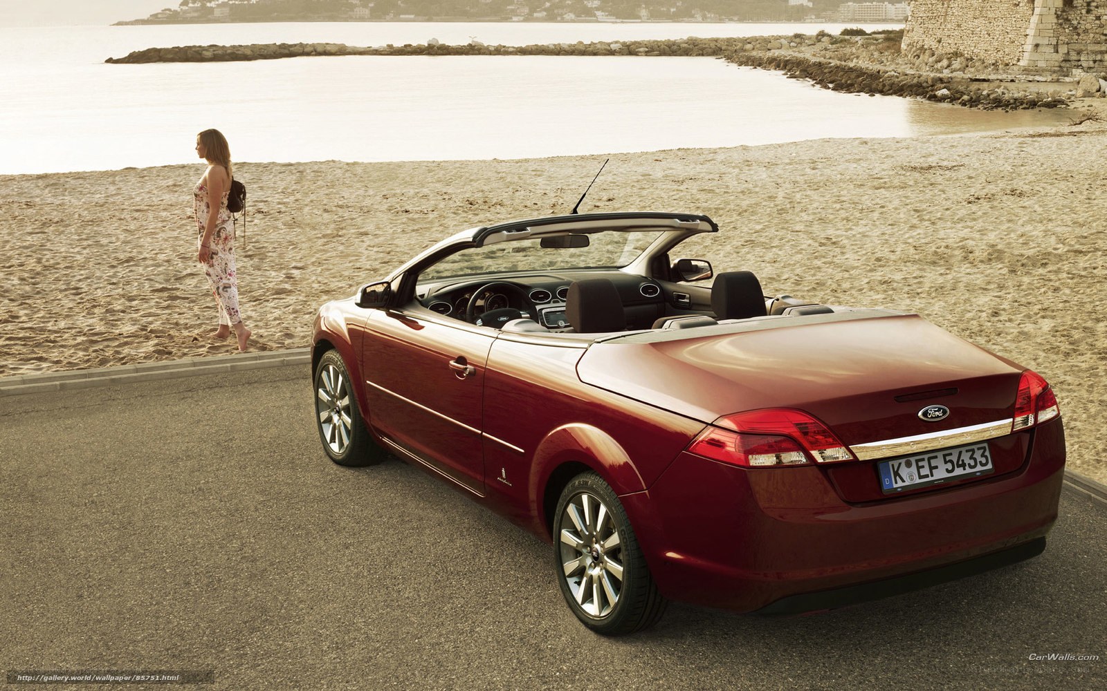 Red convertible on beach