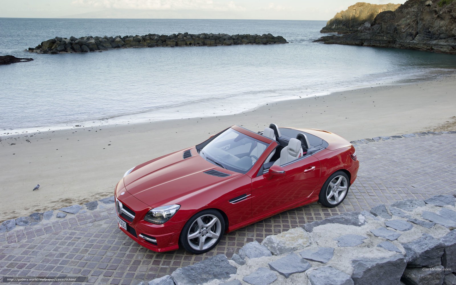 Red convertible on beachside path