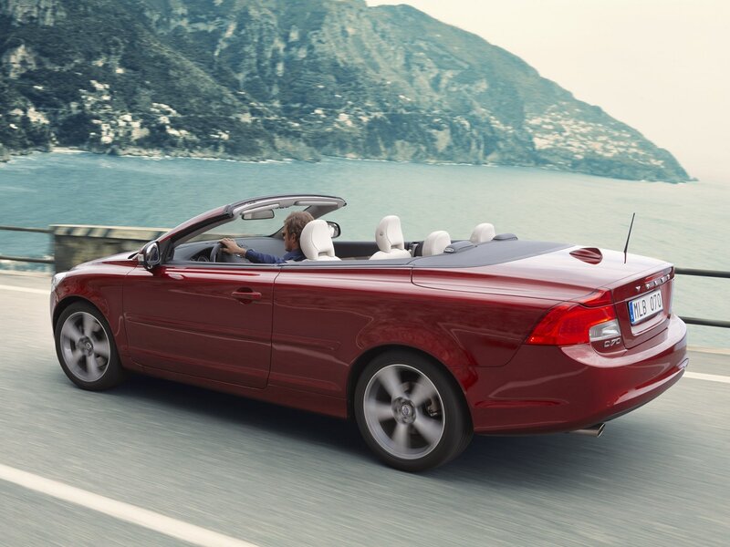 Red convertible on coastal road