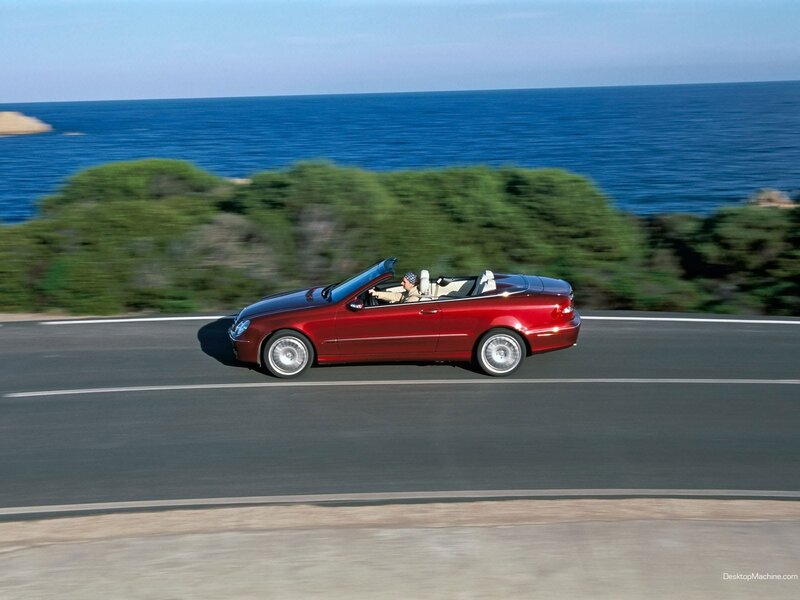 Red convertible on coastal road