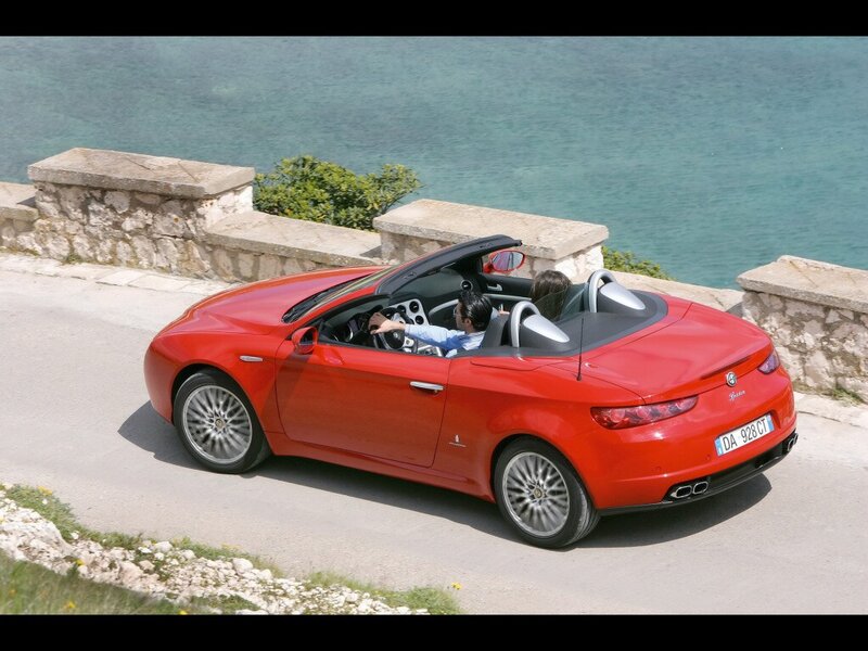 Red convertible on coastal road