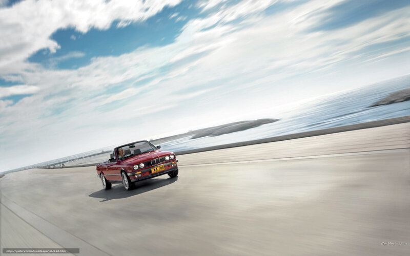 Red convertible on coastal road