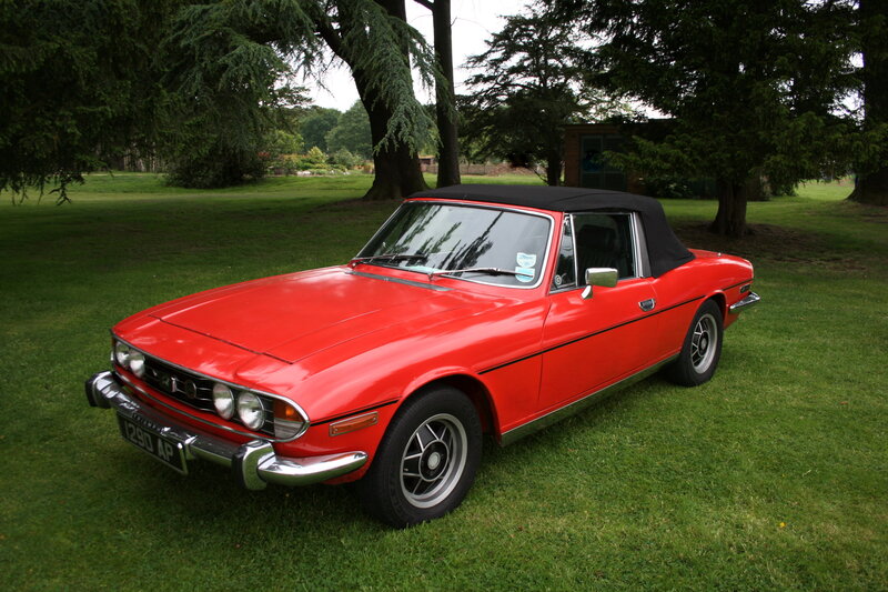 Red convertible on grass