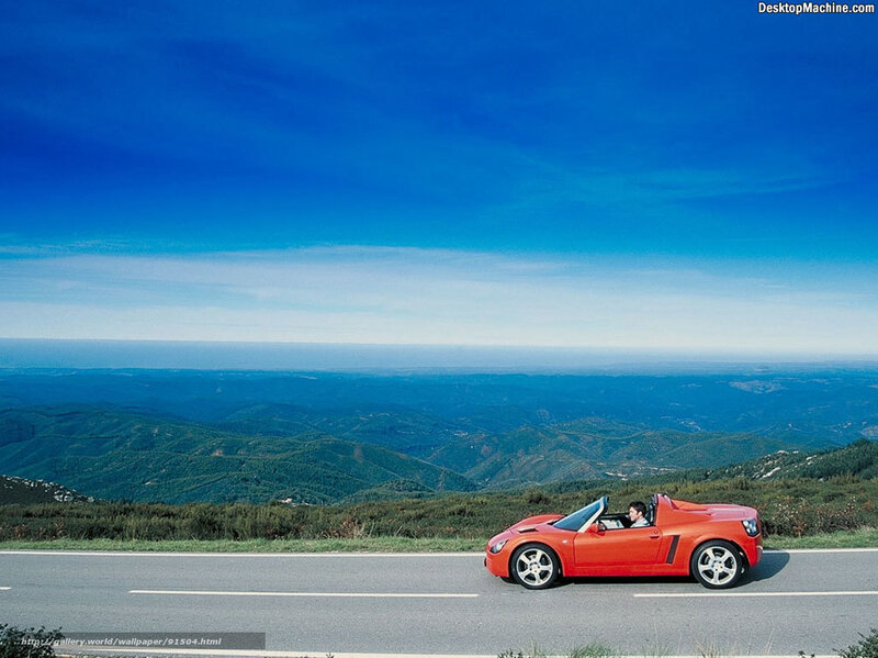 Red convertible on mountain road