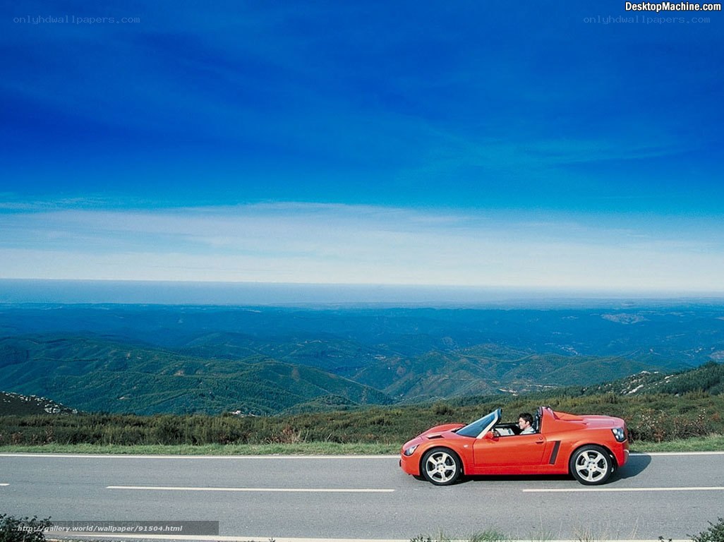 Red convertible on mountain road