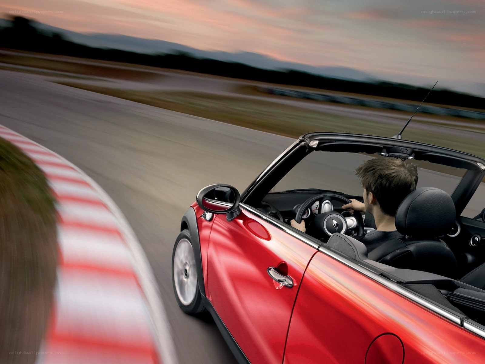 Red convertible on racetrack