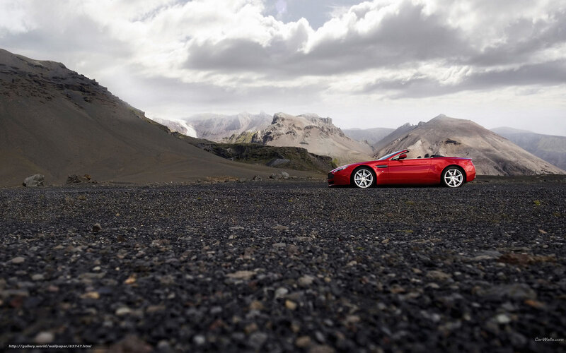 Red convertible on volcanic landscape