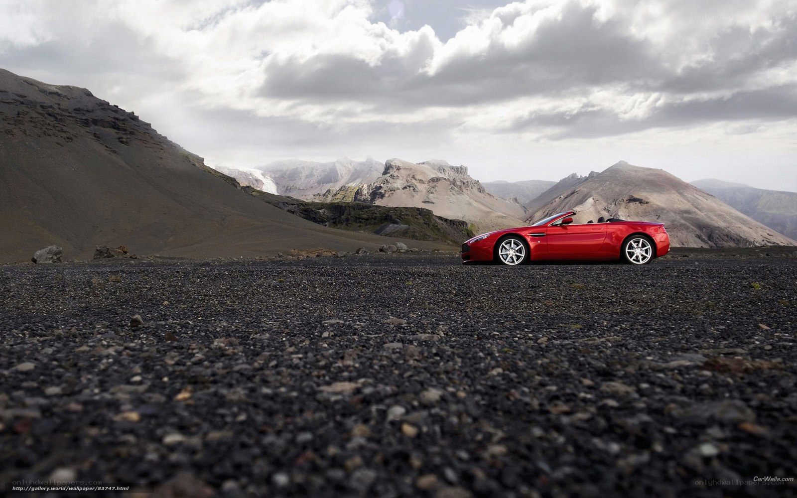 Red convertible on volcanic landscape
