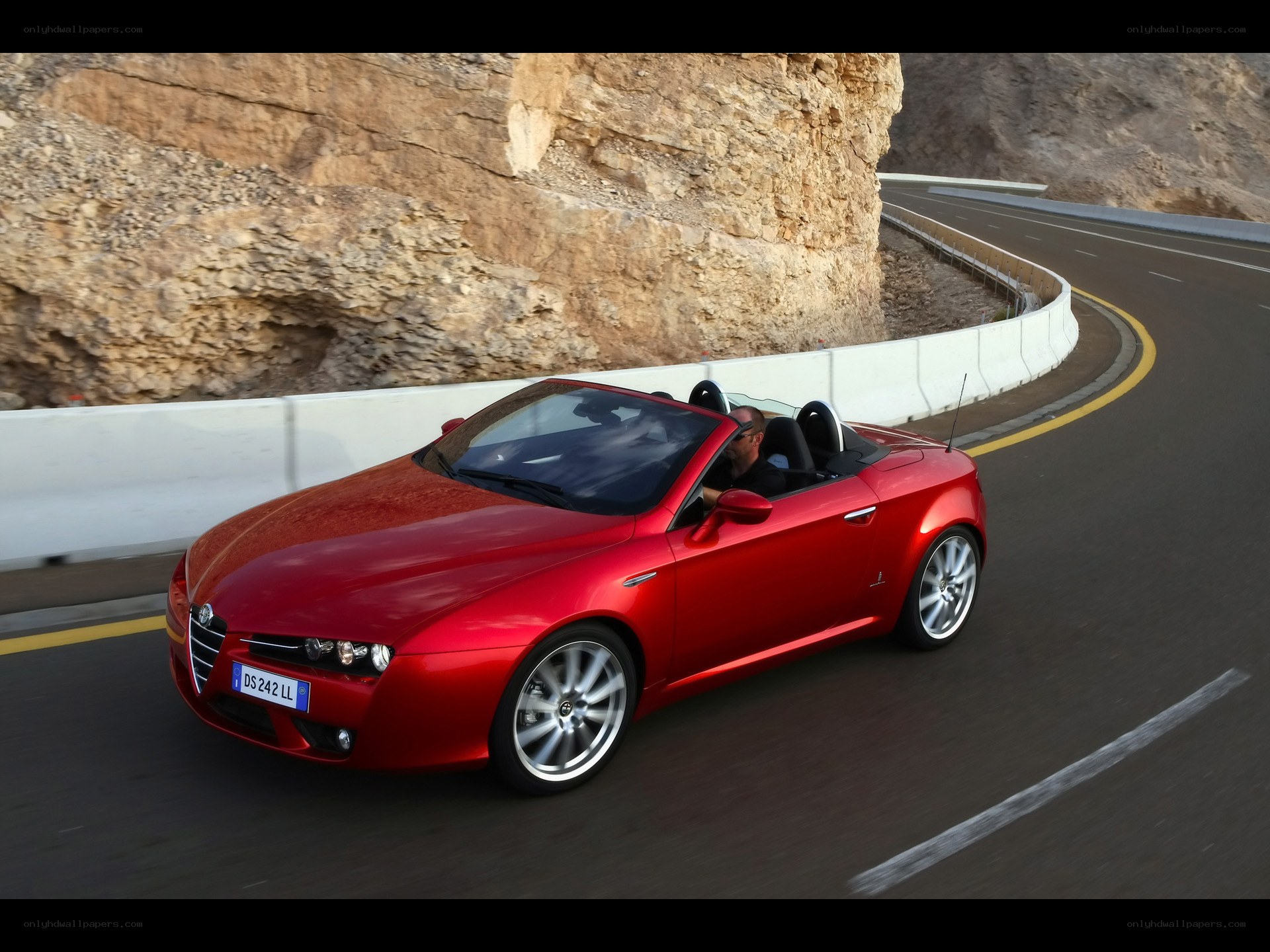 Red convertible on winding road