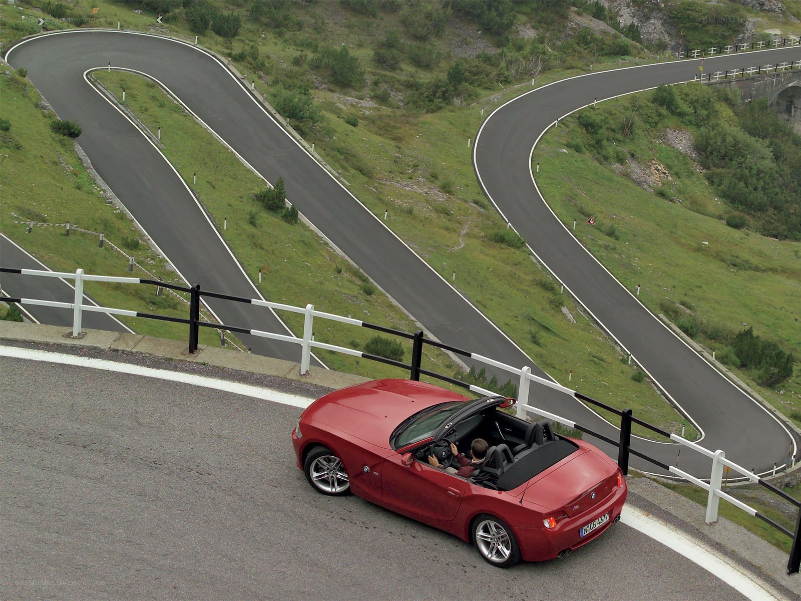 Red convertible on winding road