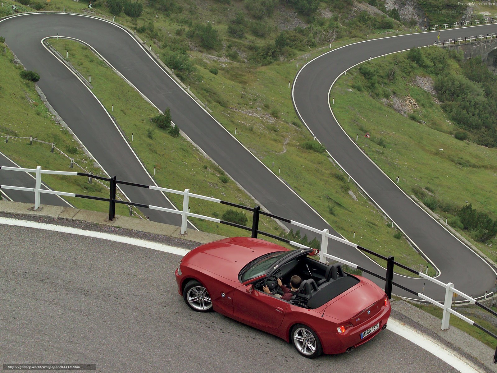 Red convertible on winding road