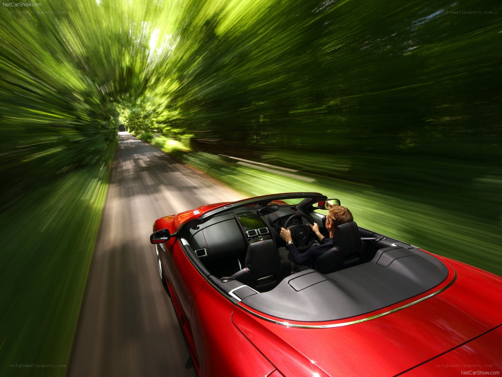 Red convertible speeding on a road