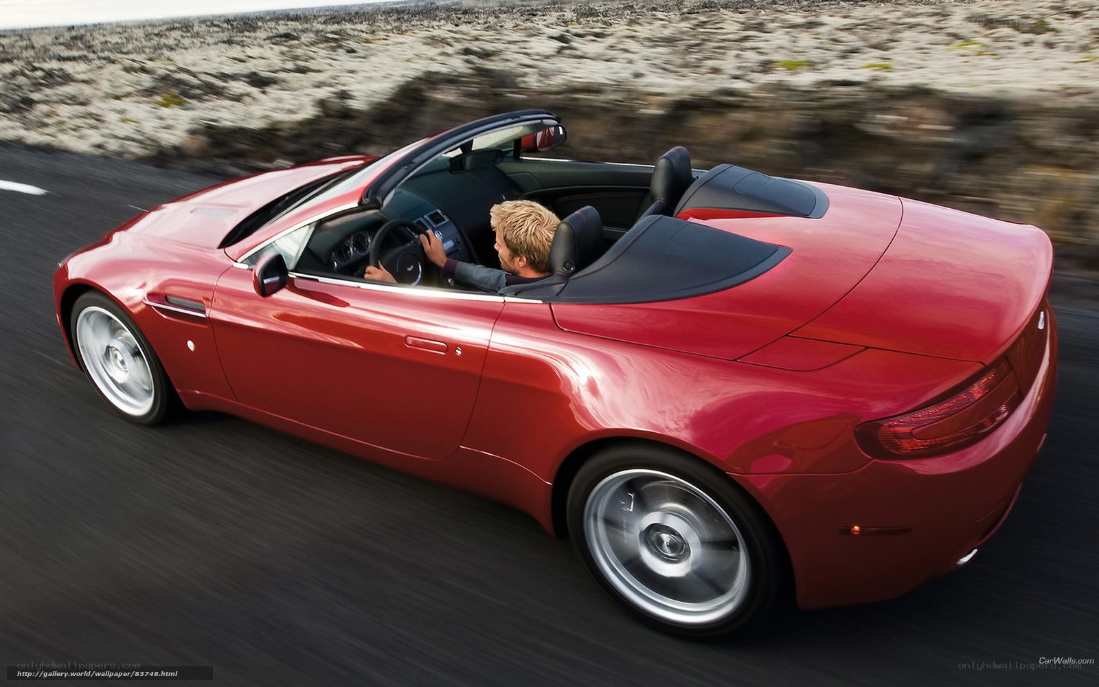 Red convertible sports car driving