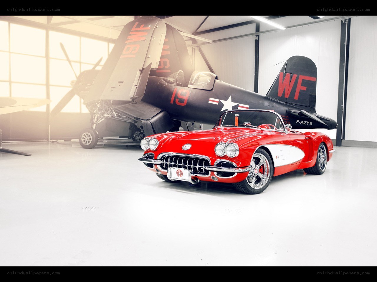 Red Corvette and vintage plane