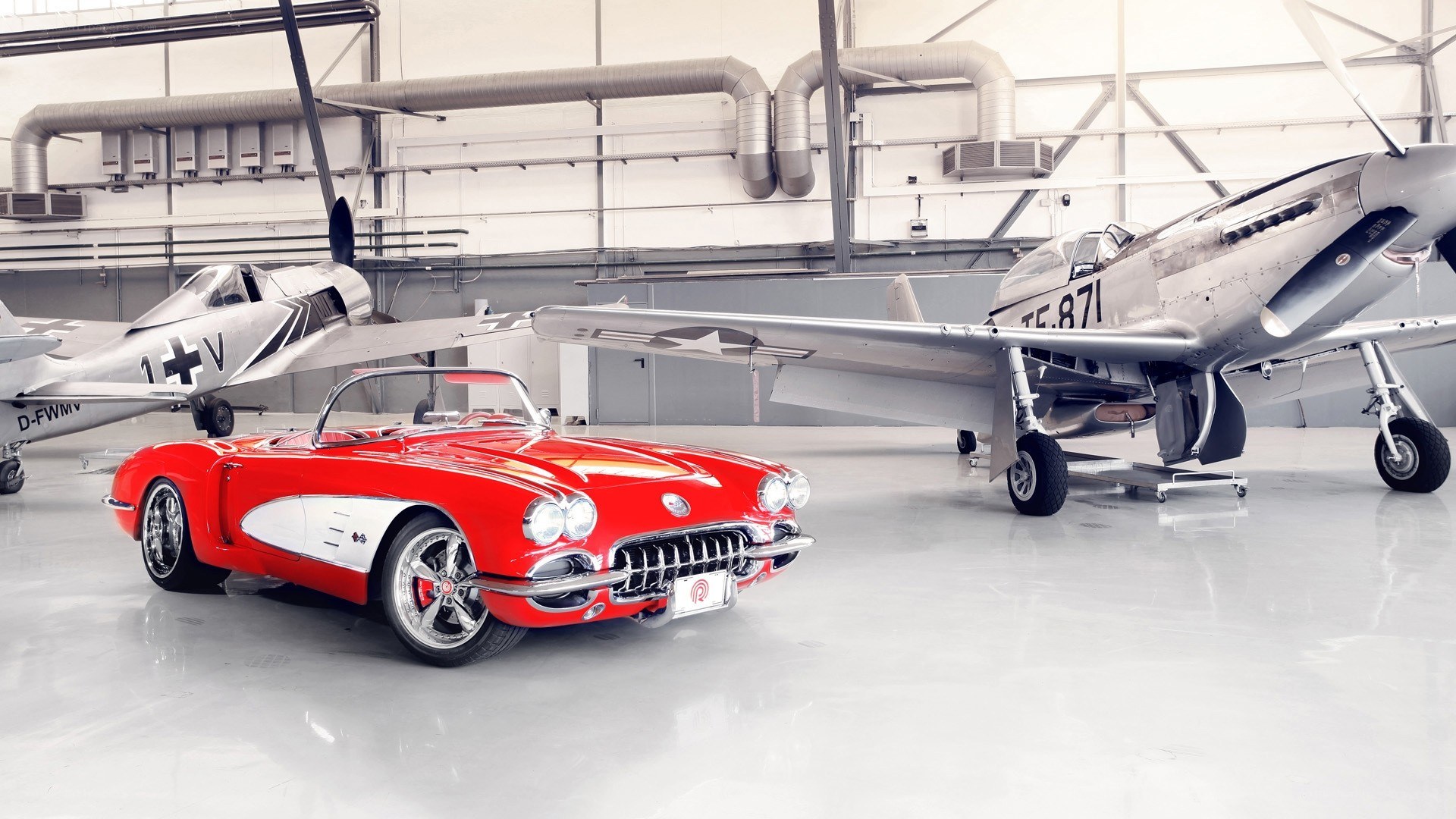 Red Corvette and vintage planes