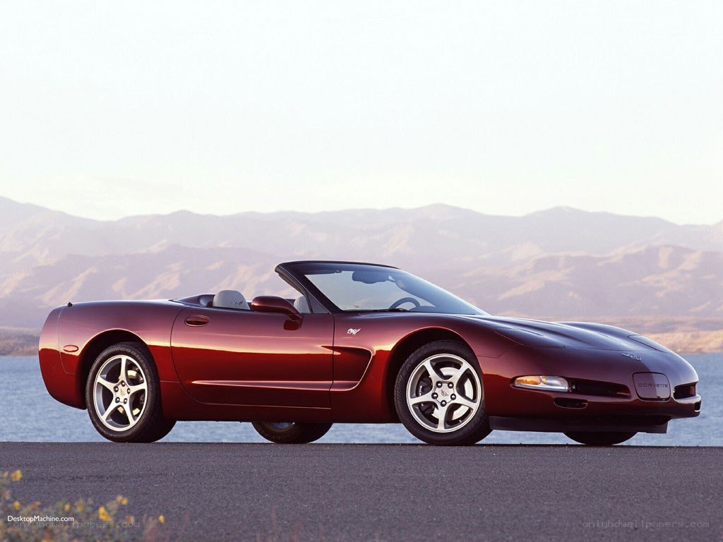 Red Corvette convertible by lake