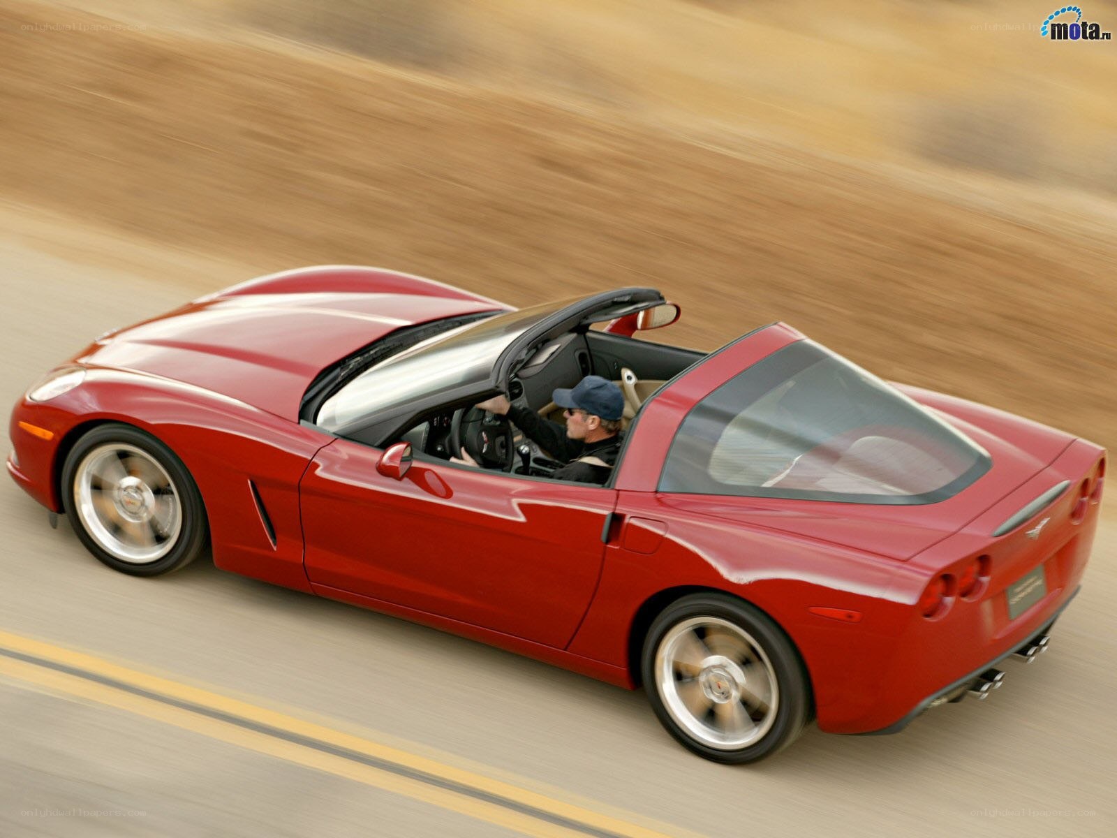 Red Corvette convertible in motion