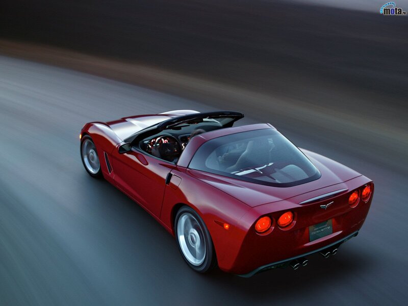 Red Corvette convertible in motion