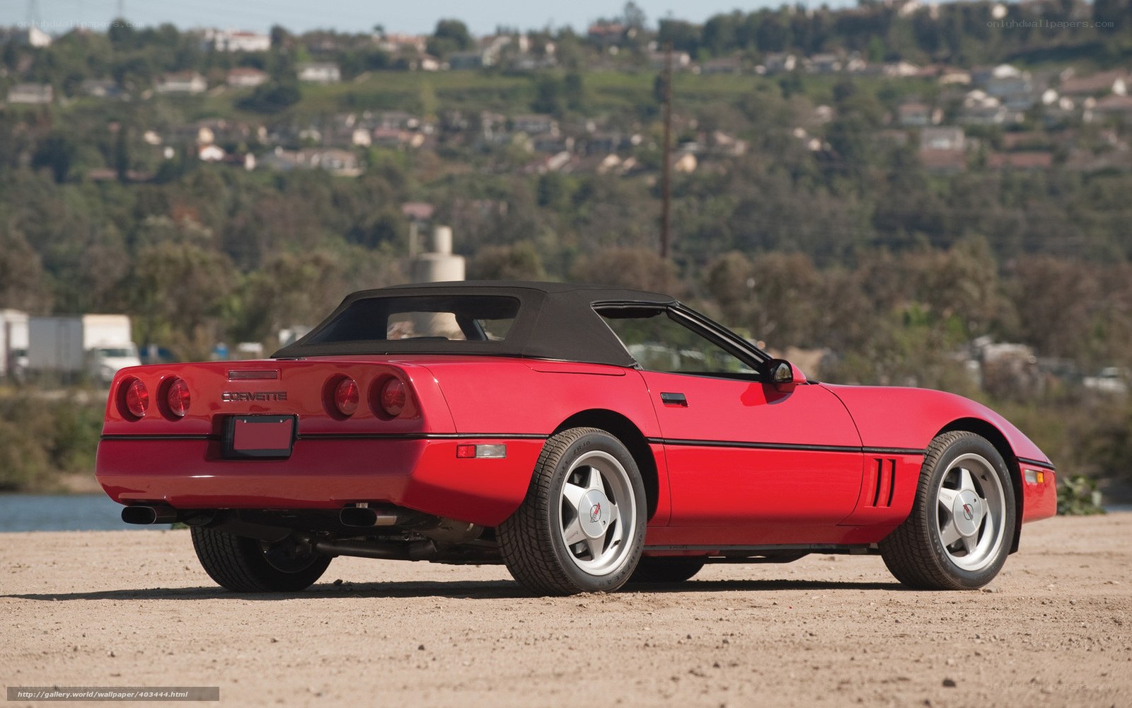 Red Corvette convertible on beach