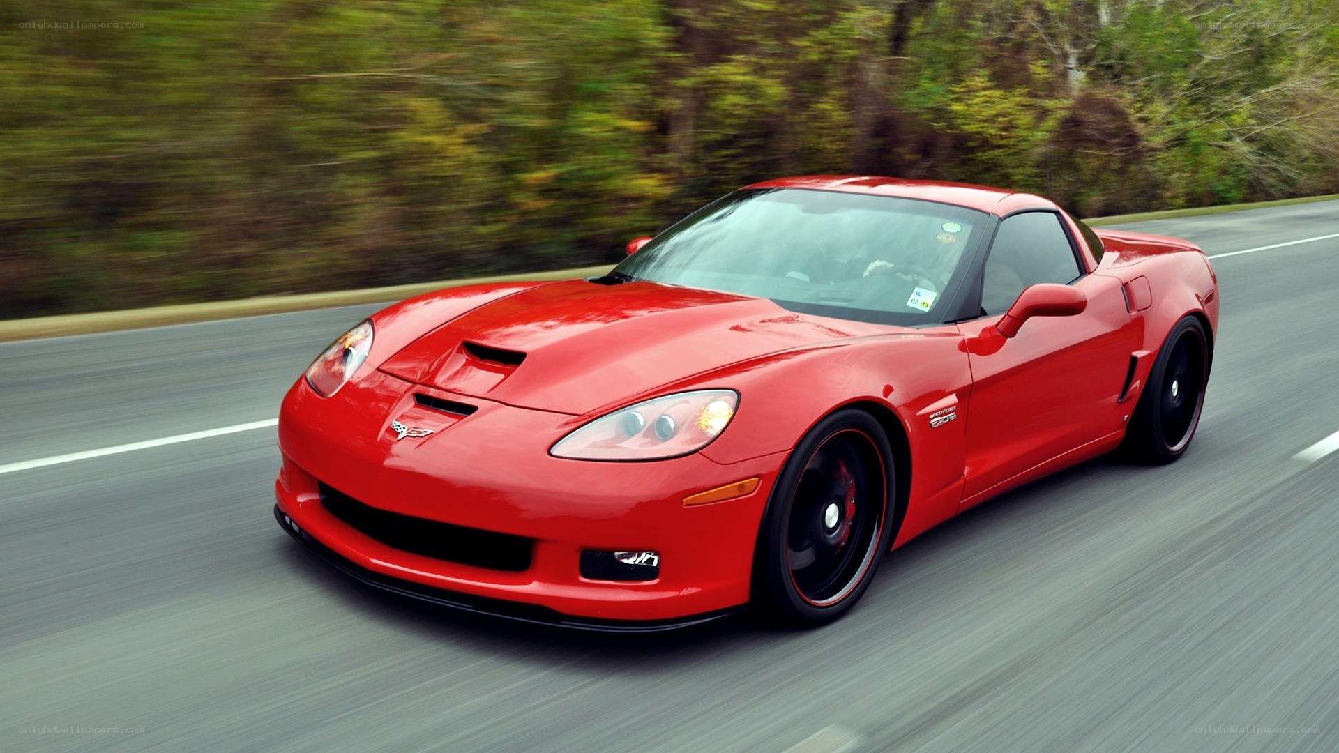 red corvette driving on road