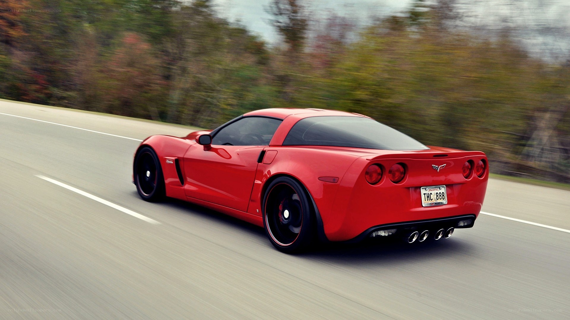 red corvette driving on road