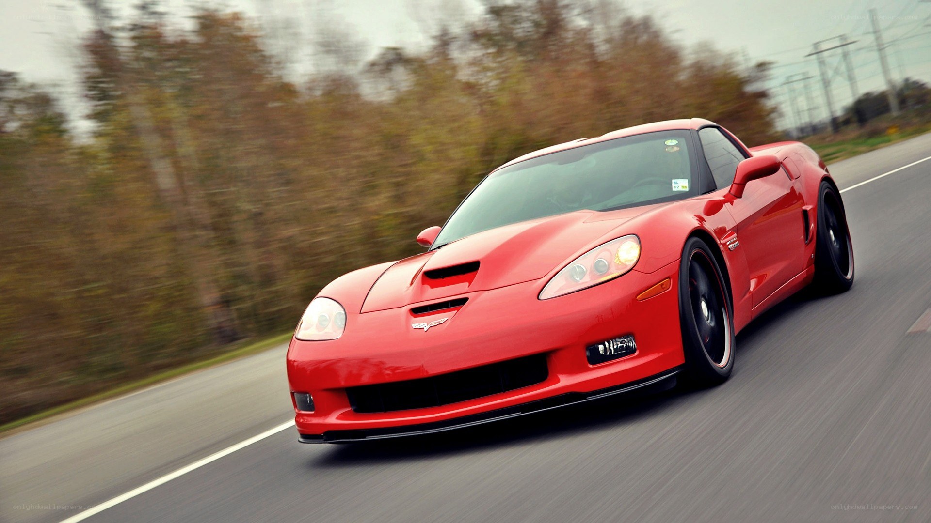 red corvette driving on road
