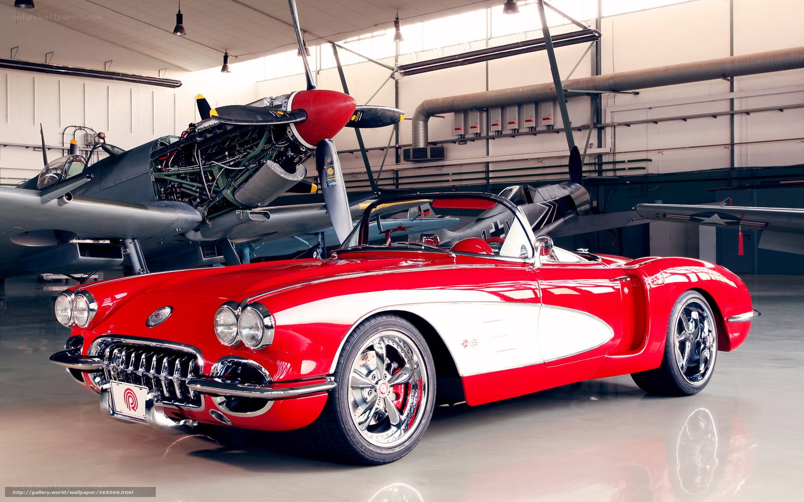 Red Corvette in aircraft hangar