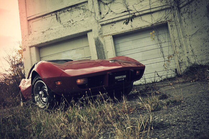 Red Corvette in an abandoned lot