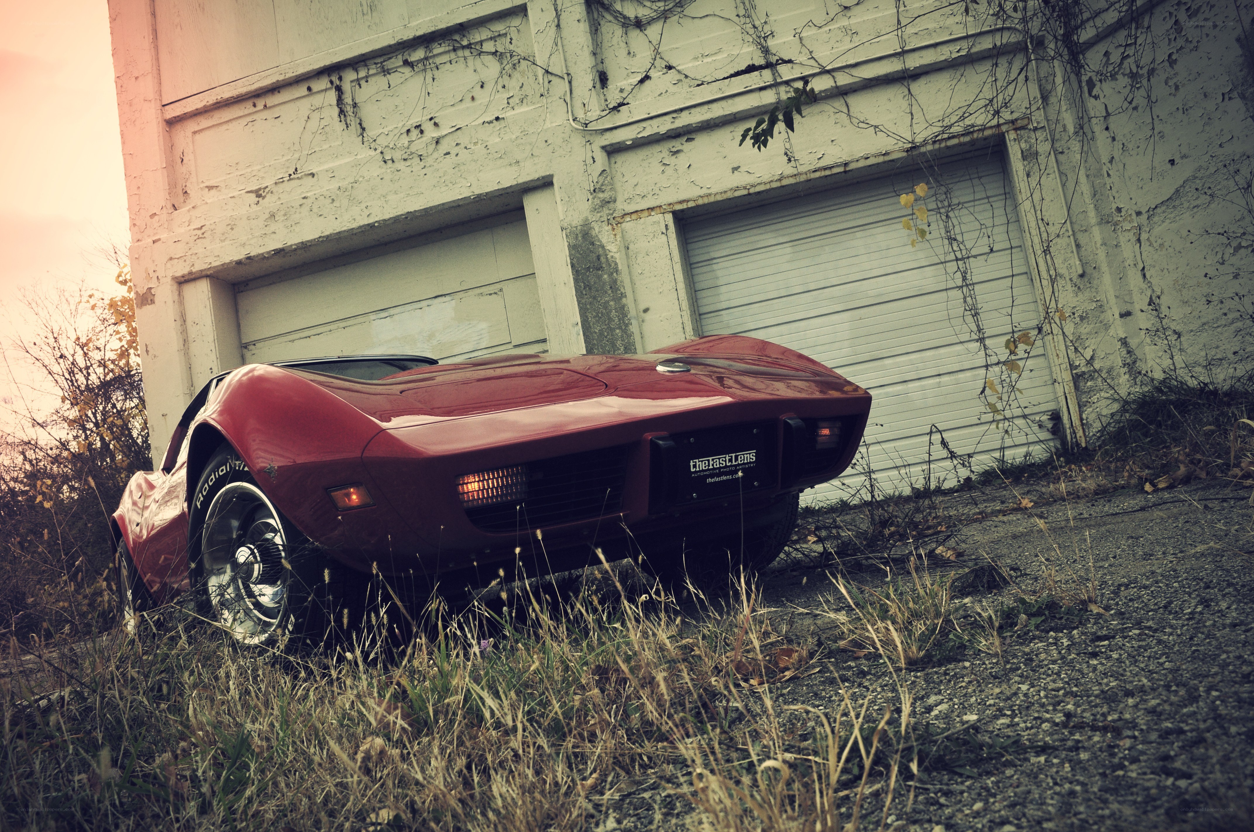 Red Corvette in an abandoned lot