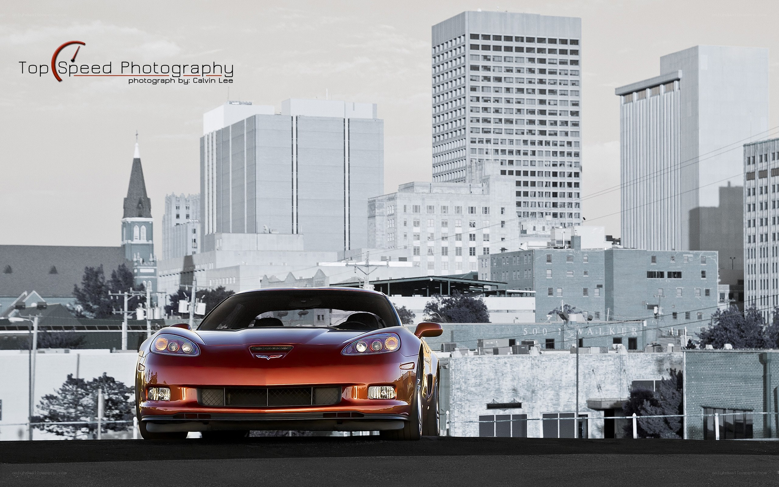 Red Corvette in cityscape