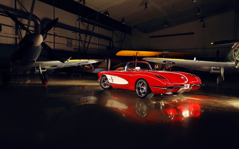 Red Corvette in Hangar — Dramatic, Night