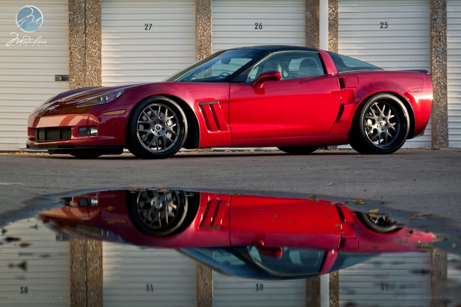 Red Corvette in puddle reflection