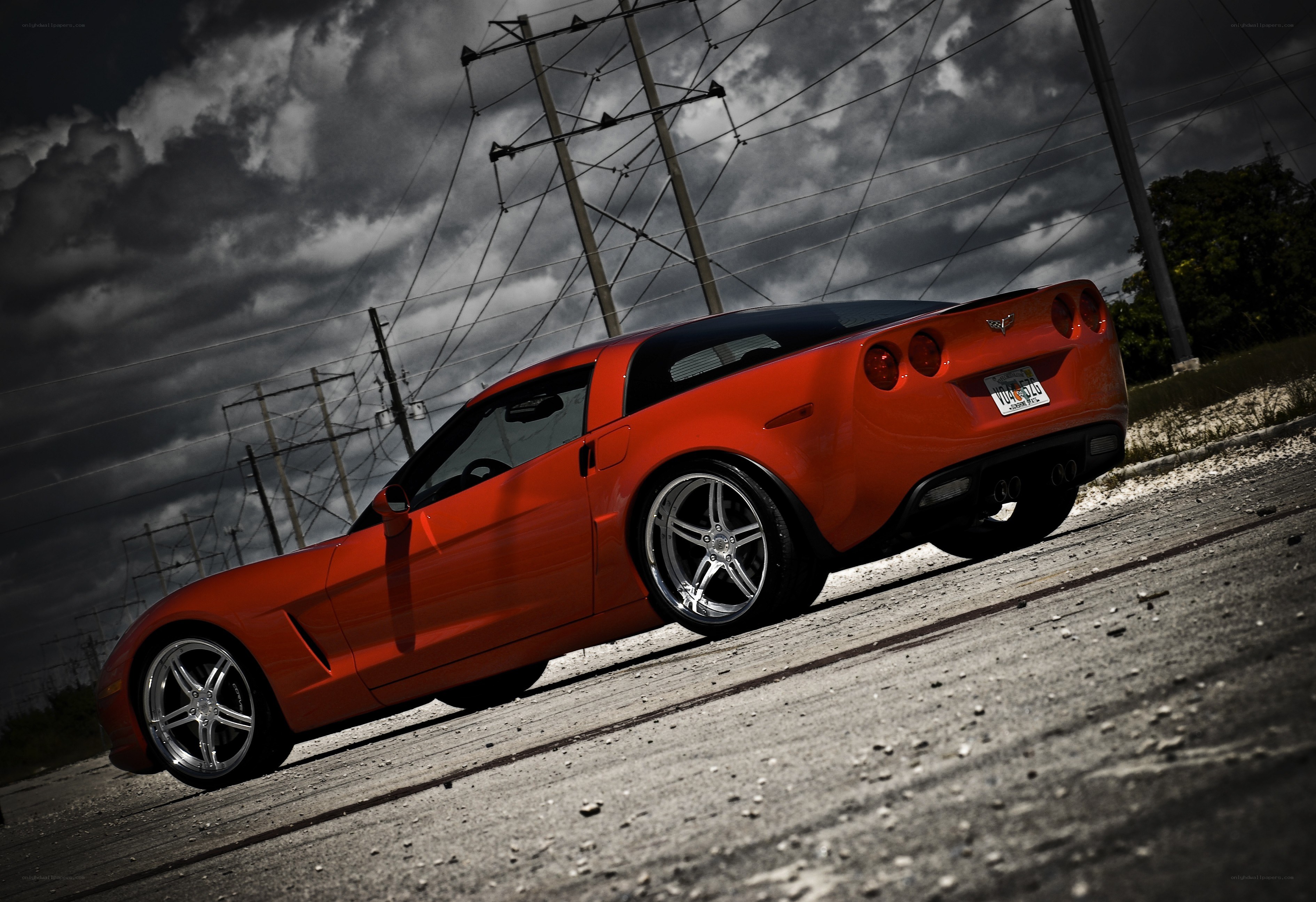 Red Corvette on a cloudy day