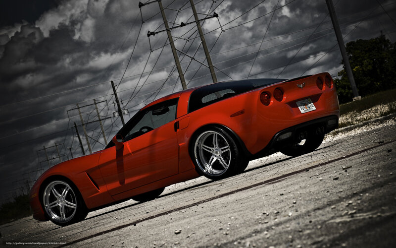 Red Corvette on a cloudy day