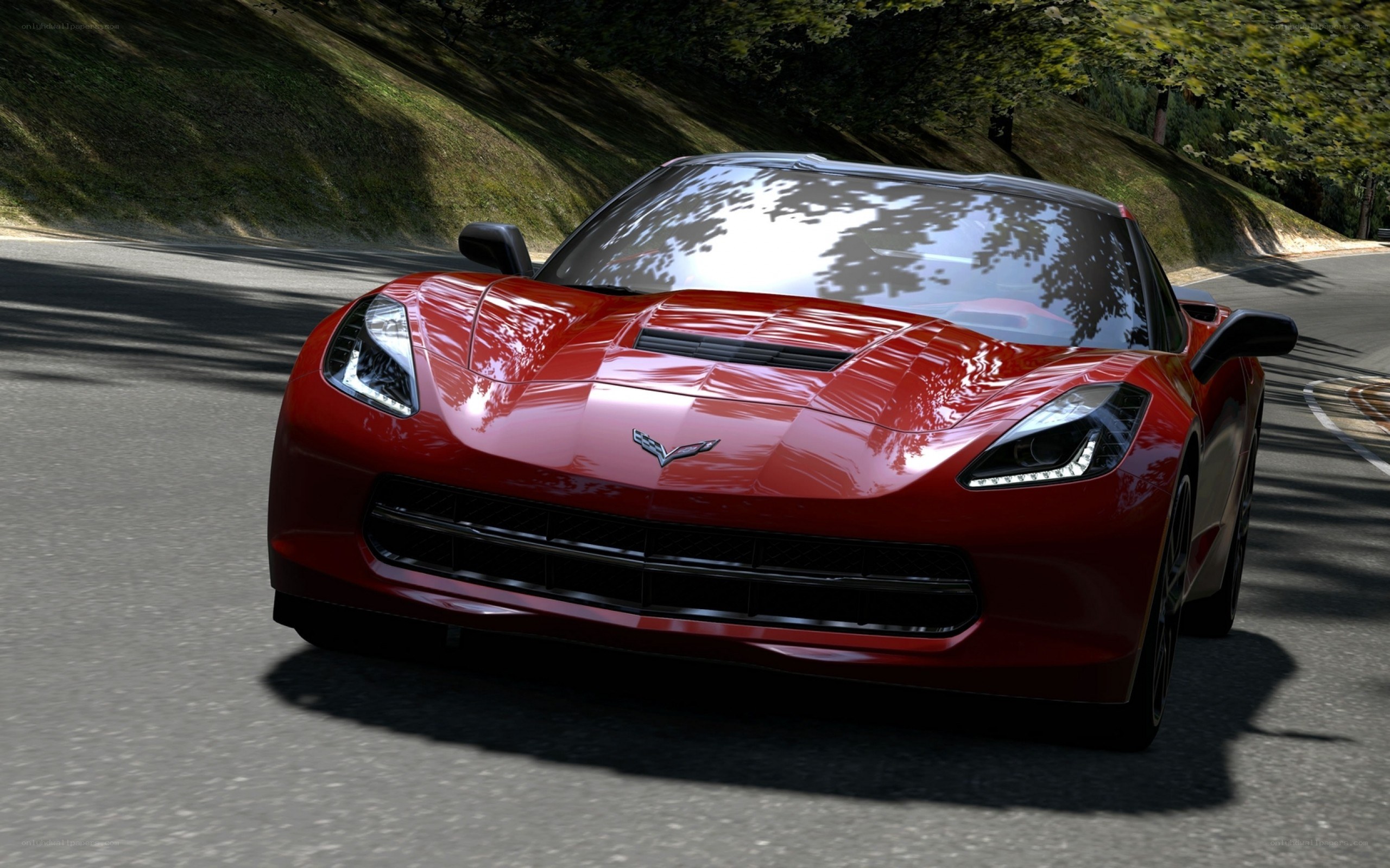 Red Corvette on a winding road