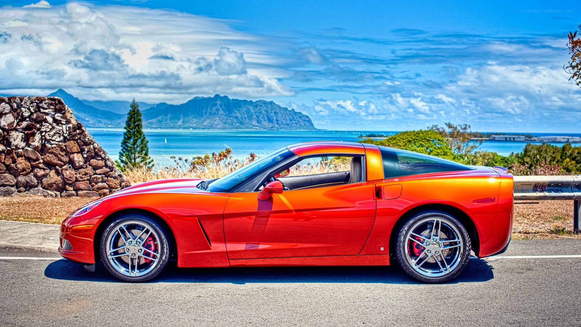 Red Corvette on coastal road