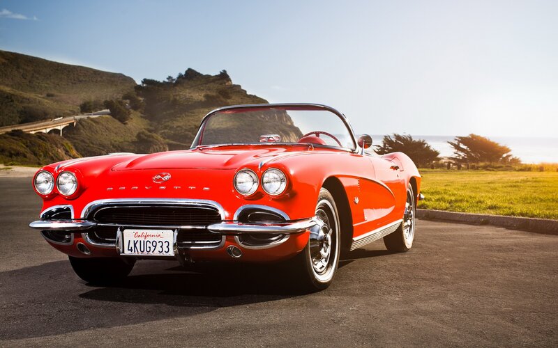 Red Corvette on coastal road