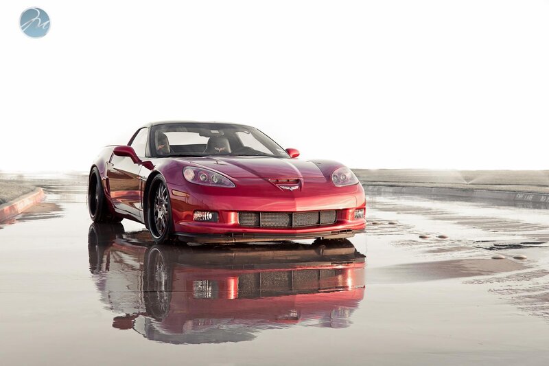 Red Corvette on wet pavement
