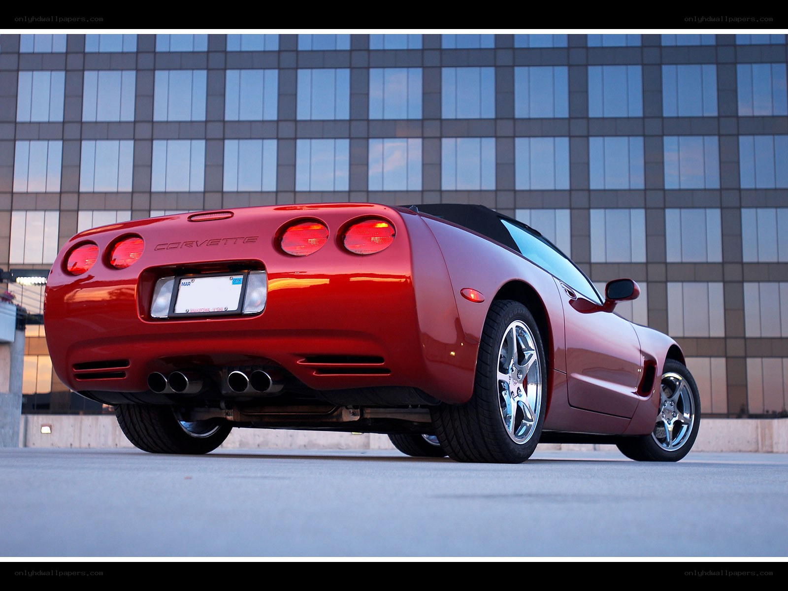 Red Corvette parked in city