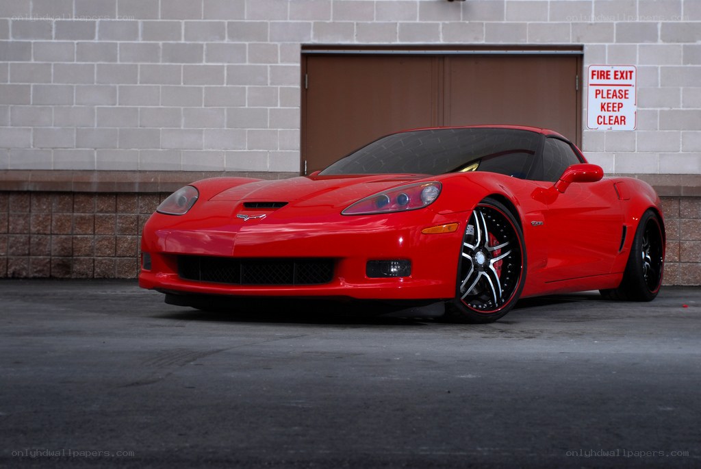 Red Corvette parked in garage