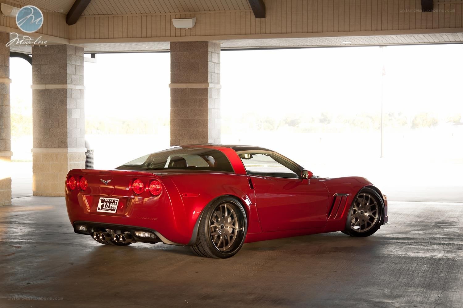 Red Corvette parked in garage