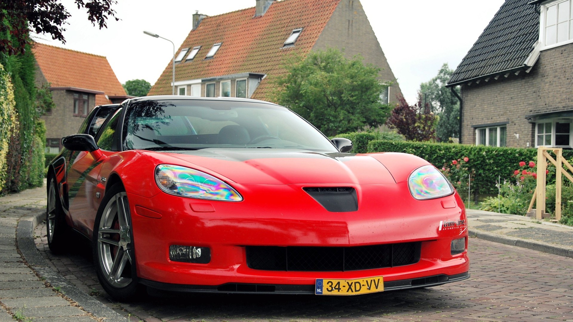 Red Corvette parked on a street