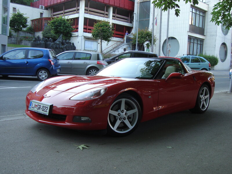 Red Corvette parked on street