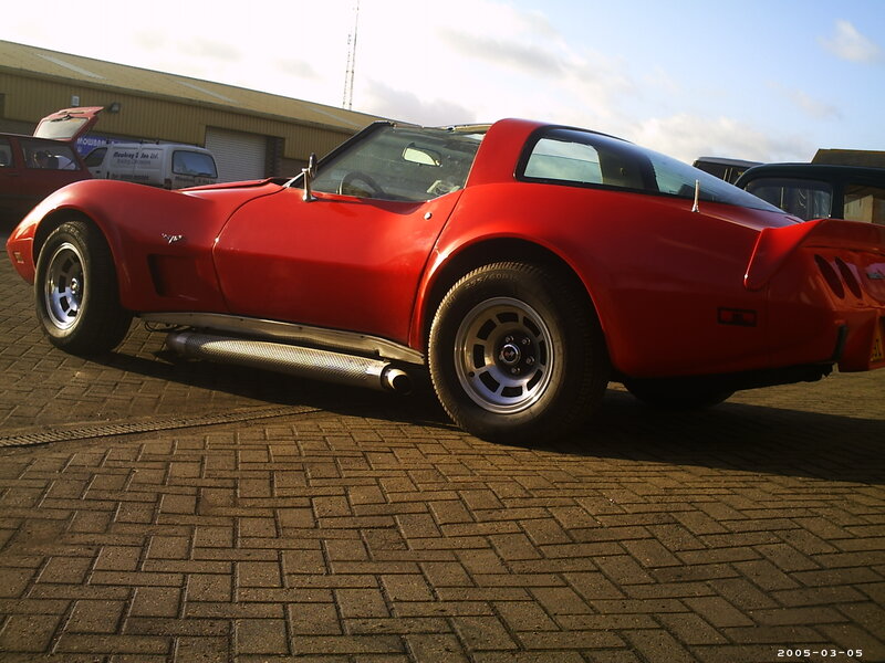 Red Corvette parked outside