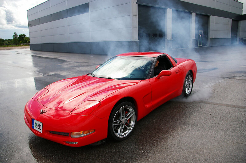 Red Corvette performing burnout