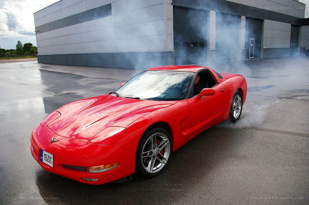 Red Corvette performing burnout