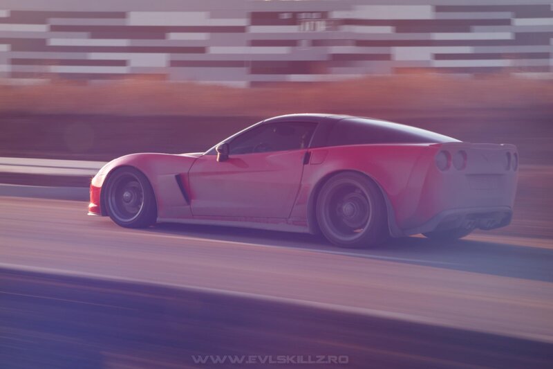 red corvette speeding on track