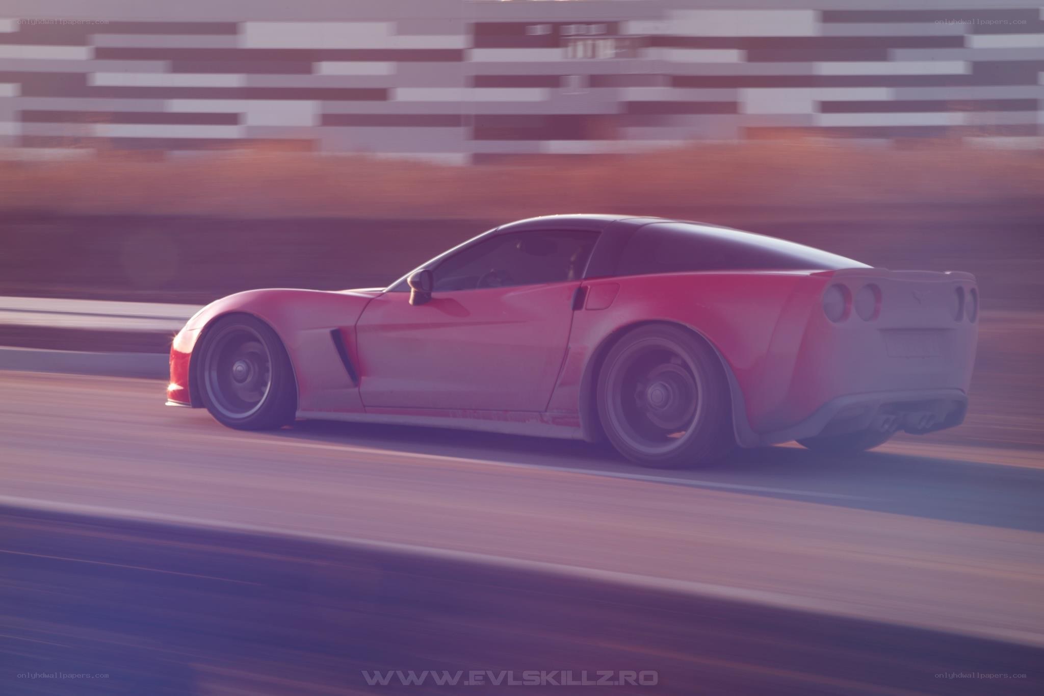 red corvette speeding on track