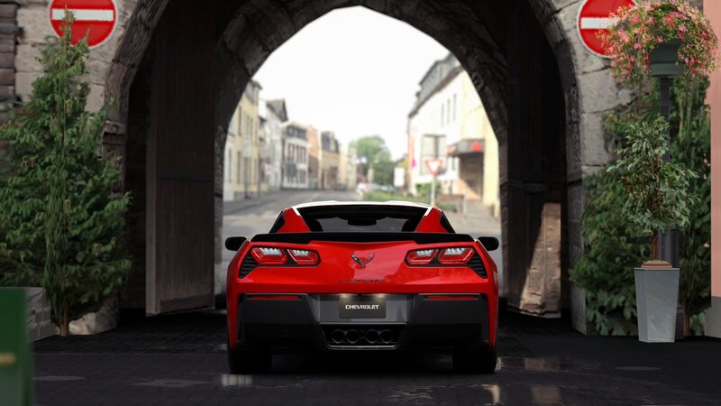 Red Corvette under stone arch