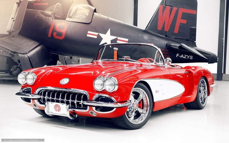 Red Corvette with plane in background